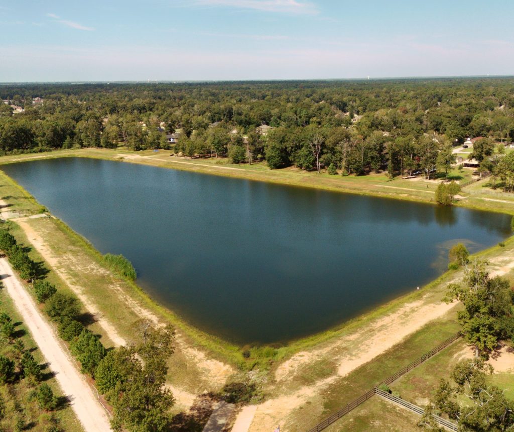 Aerial view of the Deer Trail II pond, with trees and homes around it